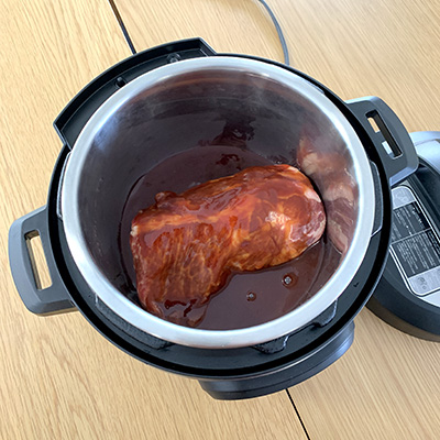 豚肩ロースをインスタントポットの鍋に入れ、他の調味料とパイナップルを全て加えます。